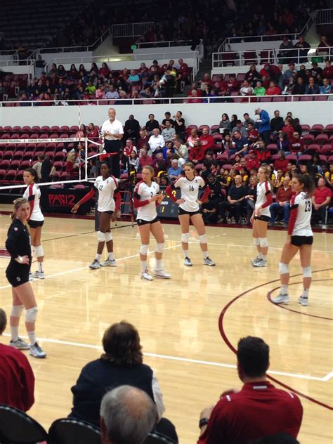 Stanford Volleyball players look over and listen to last minute ...