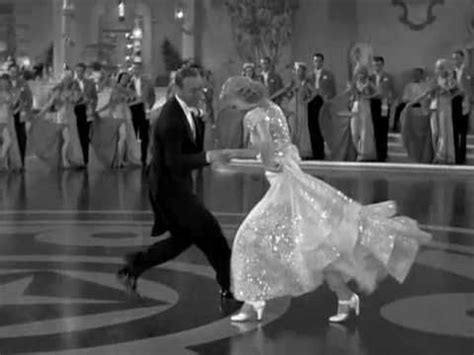 a man and woman dancing on a dance floor in front of a group of people