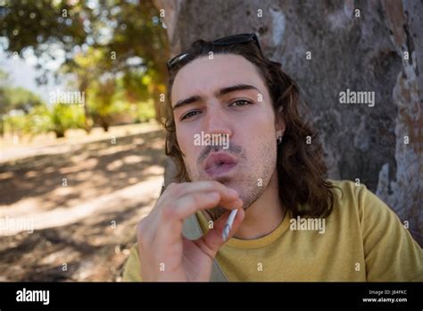 Addicted man smoking weed in the park Stock Photo - Alamy