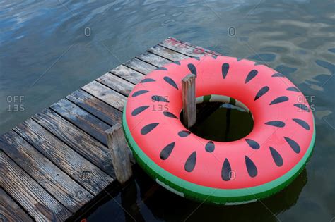 Elevated view of inner tube float and dock on lake stock photo - OFFSET