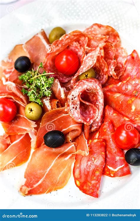 Italian Salumi Meat Platter - Prosciutto Ham, Salami Olive and Cherry Tomato. Stock Photo ...