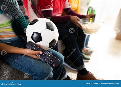 Mid Section of Family Watching Sports on TV at Home Stock Image - Image ...