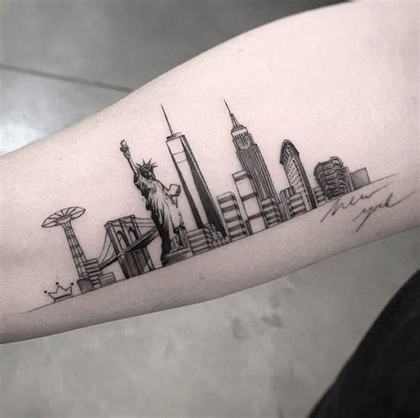 Fine line New York Skyline tattoo on the inner forearm