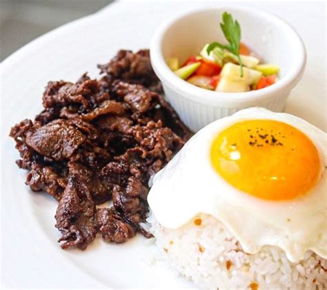 Tapsilog is an abbreviation from the combination of beef tapa, garlic fried rice (sinangag), and ...