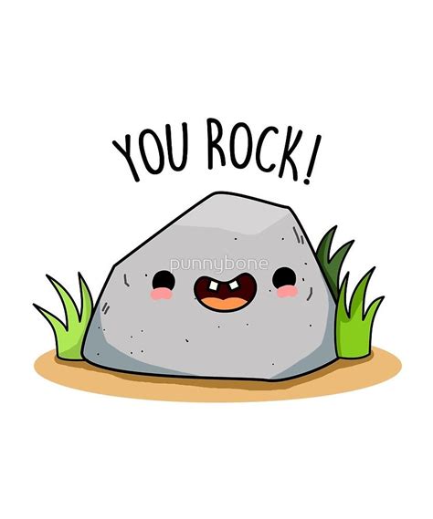 a rock with the words you rock written on it and grass around it, in front of