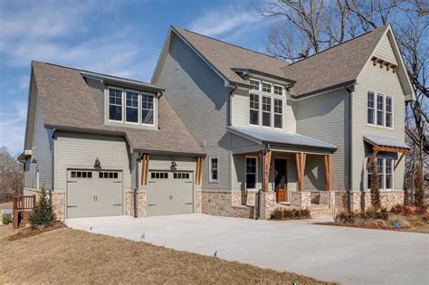 a large gray house with two car garages