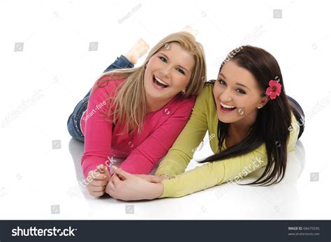 Two Pretty Girl Friends Having Fun And Laughing On The Floor. Isolated On White Background Stock ...