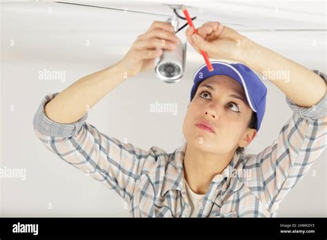 pretty female cctv installing cctv Stock Photo - Alamy