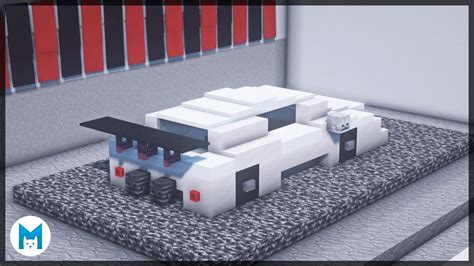 an image of a car made out of legos on top of a mat in front of a wall