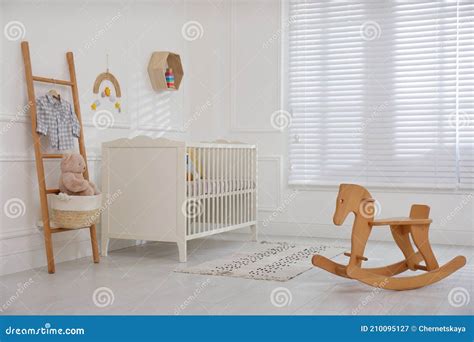 Cute Baby Room Interior with Comfortable Crib and Wooden Rocking Horse ...