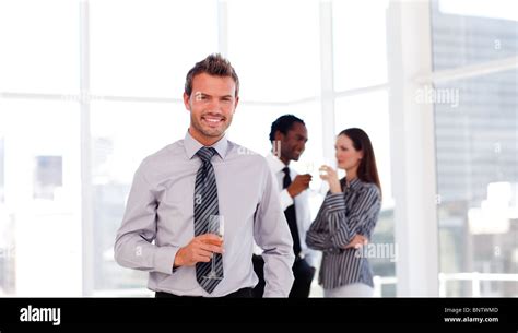 Happy businessman in the office with his team Stock Photo - Alamy