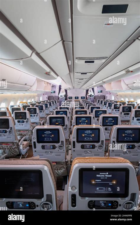 Singapore - January 2022: Singapore Airlines aircraft interior with economy class passenger ...