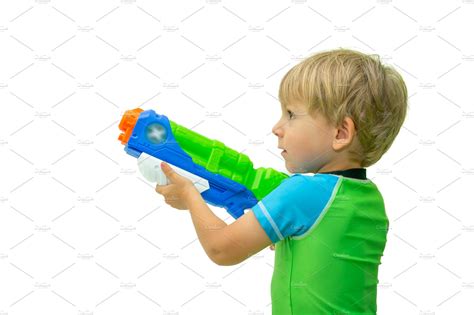 Boy holds water gun isolated on | High-Quality People Images ~ Creative ...