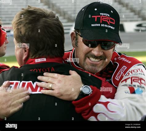 NASCAR Truck Series driver Mike Skinner, right, hugs a crew member ...