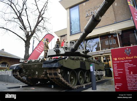 Soldiers from The King's Royal Hussars display a Challenger 2 tank outside the National Army ...