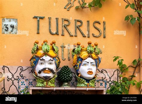 Taormina, Sicily, Italy - Colourful traditional large ceramic flower pots with painted faces on ...