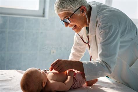 Happy Pediatrician Doctor with Baby Checking Possible Heart Defect Stock Image - Image of ...