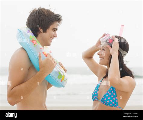 Couple smiling at each other at beach Stock Photo - Alamy