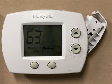 How do I replace the battery in my Honeywell thermostat?