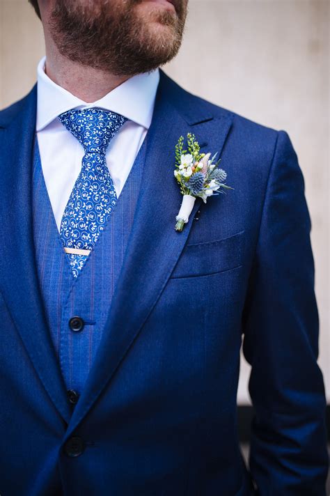 Handsome groom in a blue suit with matching details. View the full wedding here: http ...