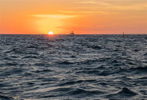 A Boat in Choppy Seas at Sunset Stock Image - Image of boat, vacation ...