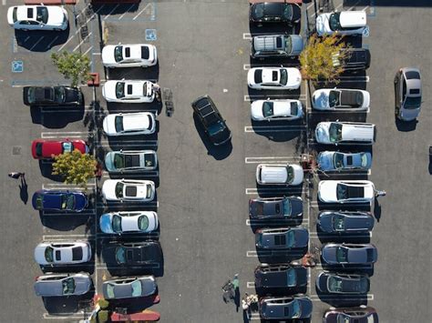 Premium Photo | Aerial top view of parking lot with many cars from ...