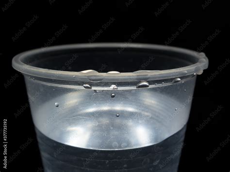 Plastic cup with water, dramatic illumination Stock Photo | Adobe Stock