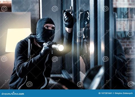 Masked Burglar Breaking into the House Stock Image - Image of dangerous, gangster: 107281661