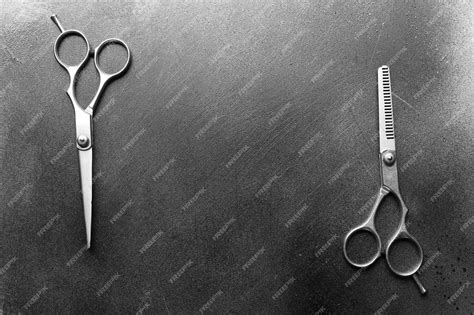 Premium Photo | Professional metal scissors lying in two different positions on the grey surface ...