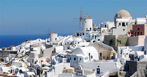 Why are most houses white painted in Santorini?