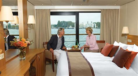 Two people sitting in a French Balcony stateroom on board a Viking river ship