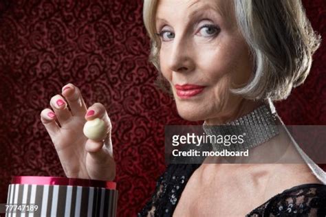 Wealthy Senior Woman With Candy High-Res Stock Photo - Getty Images