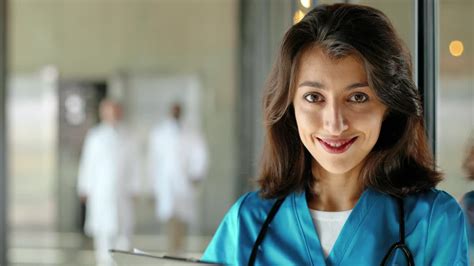 Free stock video - Portrait shot of beautiful young woman doctor smiling at camera and holding ...