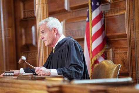 Judge banging gavel in court - Stock Photo - Dissolve