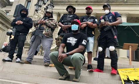 Armed black protesters decry brutality at Michigan State Capitol