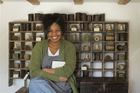 Portrait confident female shop owner at vintage display - Stock Image - F032/5082 - Science ...