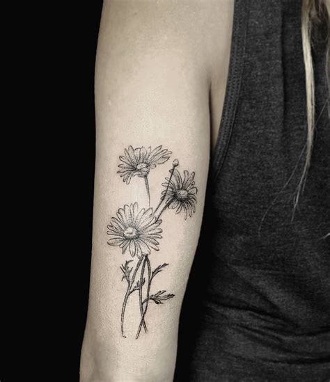 Daisies tattoo on the triceps - Tattoogrid.net