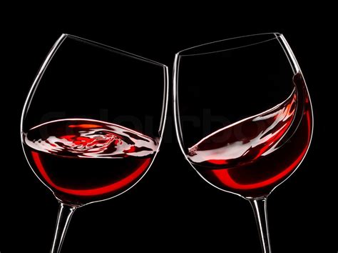 two glasses of red wine, isolated over black | Stock image | Colourbox