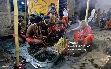 A Hindu Prist Is Busy With Devotees In A Ritual In The Eve Of Gajan ...