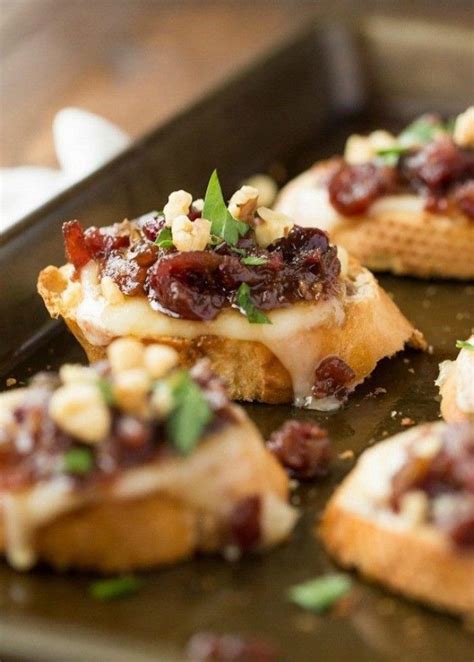 metal baking tray, containing several pieces, of grilled cheese bruschetta, topped wit ...