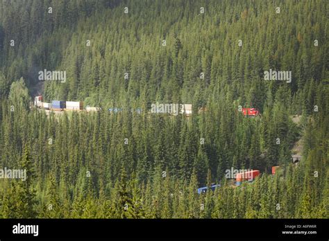 A freight train passes through the spiral tunnels of Kicking Horse Pass ...