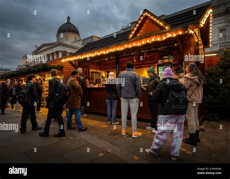 London, UK - Nov 20 2023: Trafalgar Square Christmas Market, London. People at the market stalls ...