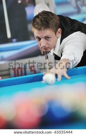 young pro billiard player finding best solution and right angle at ...