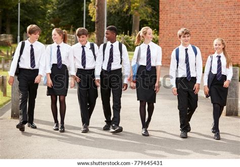 Group Of Teenage Students In Uniform Outside School Buildings