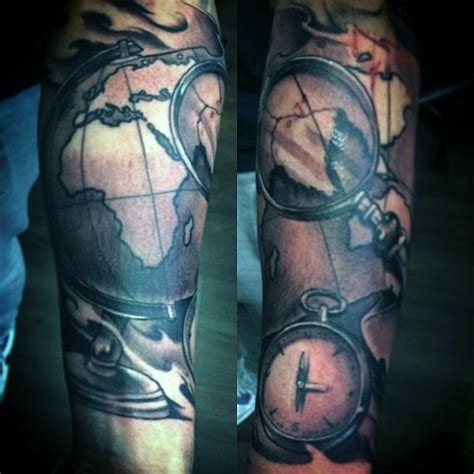 Old school style painted colored world map with compass and loupe tattoo on arm - Tattooimages.biz