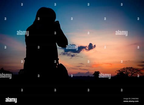 Silhouette photographer with sunset background Stock Photo - Alamy