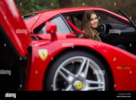 Essen, Germany. 08th Nov, 2016. A woman poses with a Ferrari F40 on display for a motor show in ...