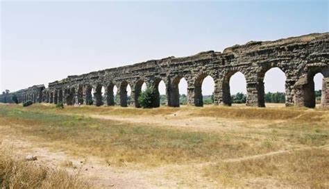 an old aqueduct in the middle of a field