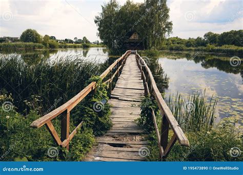 Landscape Wooden Bridge Across The Lake Stock Photo | CartoonDealer.com #56246094