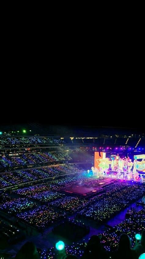 an aerial view of a concert in the middle of a large crowd at night time